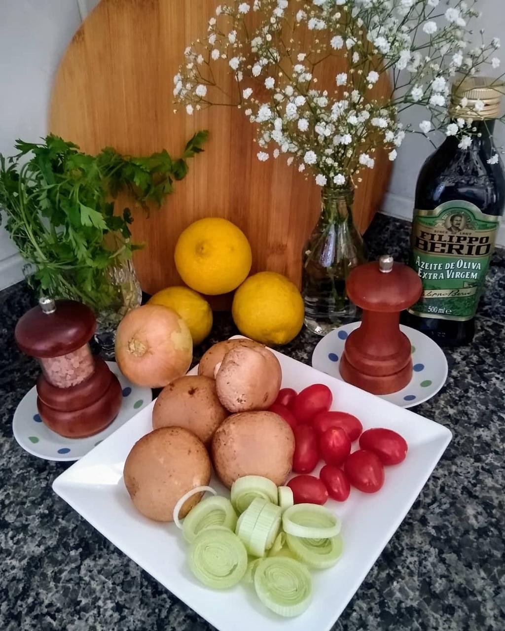 Cogumelos, alho-poró, tomates, cebola e limões organizados para o preparo das refeições